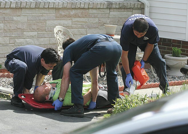 Taunton Fire fighters help one the accident victims in a car accident on Cohannet St. in Taunton.