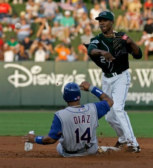 Tampa Bay second baseman B.J. Upton forces Texas baserunner Victor Diaz before firing to first during the second game of the Devil Rays-Rangers series at Disney's Wide World of Sports, outside Orlando.