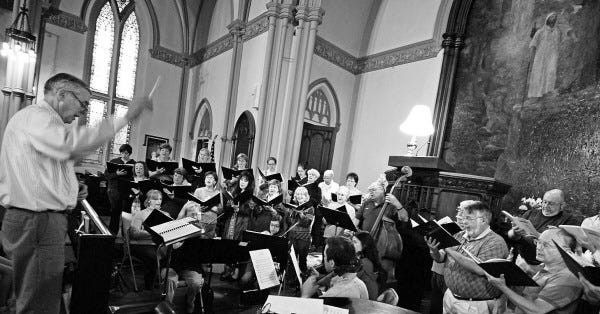 MIKE VALERI/The Standard-Times
Gerald P. Dyck, director, left, and the Greater New Bedford Choral Society prepare for Sunday's Spring Concert at the First Unitarian Church in New Bedford.