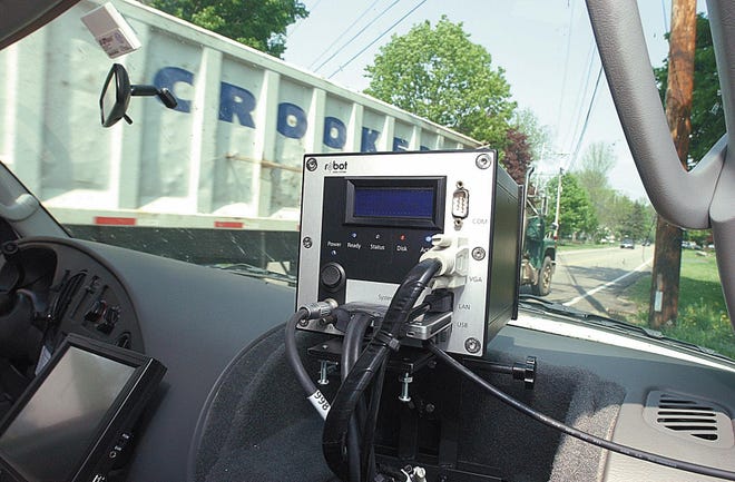 A camera sits mounted on the dashboard of an unmarked van Wednesday on Elm Street in Raynham. Raynham Police Chief Louis J. Pacheco hosted Mark Hammer, vice president of sales for Traffipax Traffic Safety Systems to learn about Traffipax’s technology