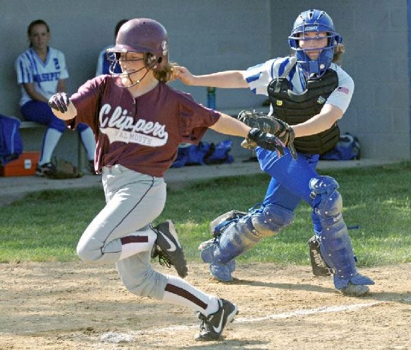 Falmouth’s Kathy Womboldt avoided the tag of Mashpee’s Kerri Bergquist but was called out for missing home plate.
