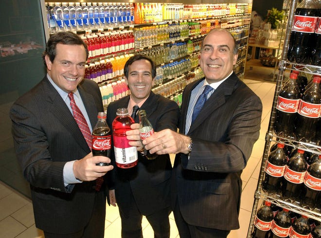 From left, Sandy Douglas, president of Coca-Cola North America, Glaceau founder J. Darius Bikoff and Muhtar Kent, president of The Coca-Cola Co., celebrate their companies' deal.