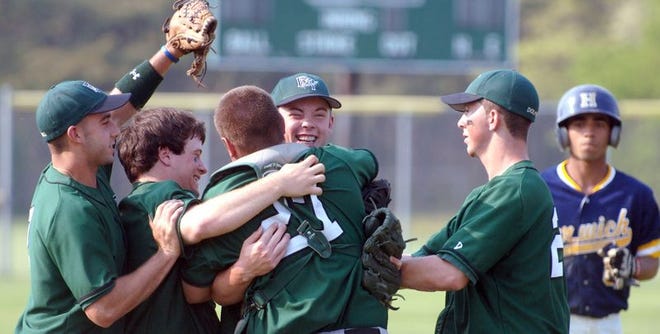 Dennis-Yarmouth freshman Brian Sweeney, center, gets swarmed by his teammates after picking up a 7-6 win over Harwich in relief for the Dolphins, who qualified for the MIAA baseball tournament in their regular-season finale.