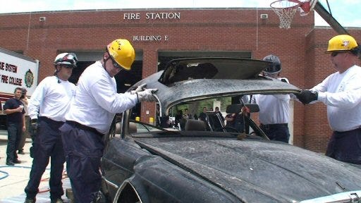 Members of Central Florida Task Force 4 remove the roof of a car in an extrication exercise at the Florida State Fire College in Lowell on Friday. The training was held on site after the grand opening of the new urban search and rescue training facility at the Fire College.