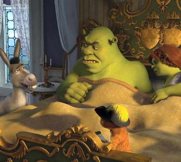 Shrek and Fiona are awakened by Donkey and Puss in Boots (at foot of bed) in “Shrek the Third.”