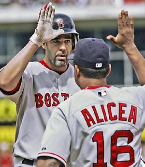 Mike Lowell is congratulated by Luis Alicea after singling in the go-ahead run in the 8th inning.