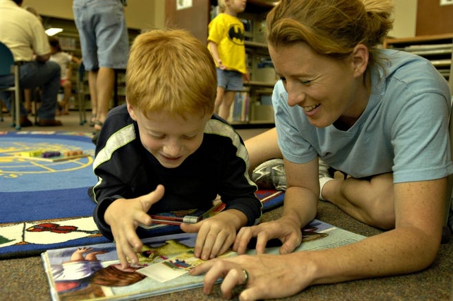 Shannon Sigmon and her son, Corey, enjoy a book together during the 2005 Children's Book Festival at the Marion County Library.