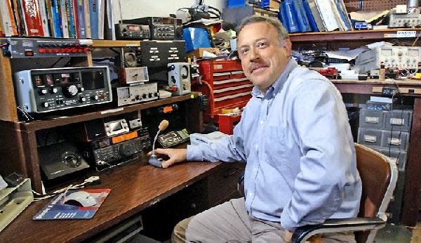 Ralph Swensen, who operates his two-way radio from the basement of his East Falmouth home, is one of the “hams” affected by the Air Force decision to clean up airwave interference to maximize PAVE PAWS radar performance.
