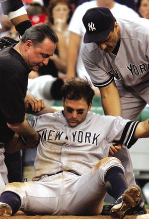 New York Yankees manager Joe Torre, right, and trainer Gene Monahan, left, help Doug Mientkiewicz who was injured on a play in the seventh inning of a baseball game against the Boston Red Sox, Saturday, June 2, 2007, in Boston.
