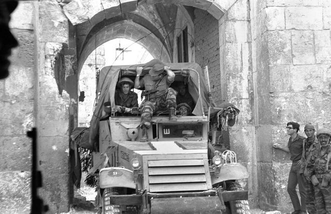Israeli soldiers ride through the Lion's Gate after capturing Jerusalem's Old City during the Six Day War in June 1967. Palestinians and Israelis marked the 40th anniversary Tuesday of the start of the Six Day War, with both sides still chasing an elusive peace.