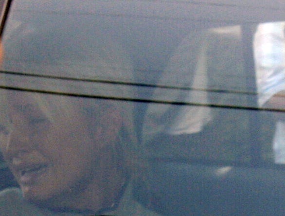 Paris Hilton is seen through the window of a Los Angeles County deputy's car Friday.