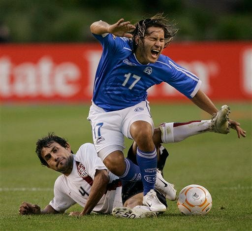 El Salvador's Dennis Alas (17) is tripped up by the United State's Pablo Mastroeni (4) during first half action of their CONCACAF Gold Cup soccer match in Foxborough, Mass., Tuesday, June 12, 2007. Mastroeni was issued a yellow card on the play.