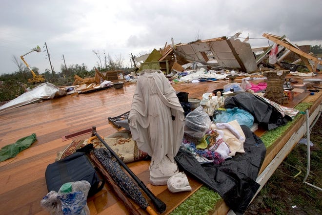 A Virgin Mary and other items are placed on what remains of the home of Nellie Byrd after tornadoes struck on Feb. 3, 2007, in DeLand.