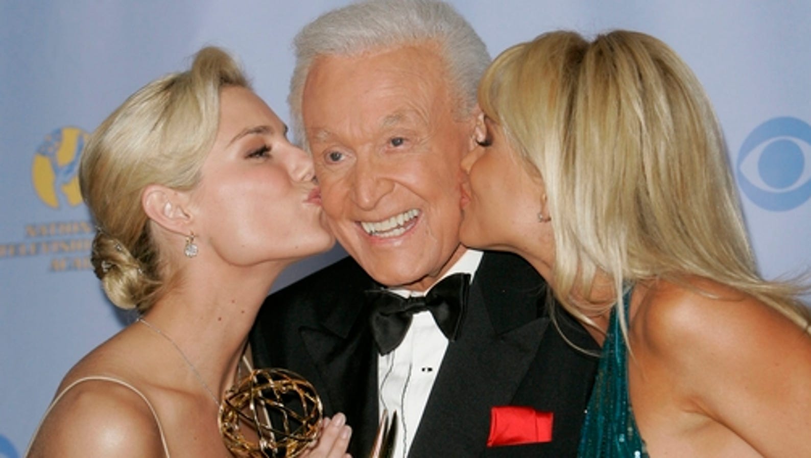 Bob Barker is kissed by the "Barker's Beauties" models as he poses with the award for outstanding game show host for his work on "The Price Is Right, at the 34th Annual Daytime Emmy Awards in Los Angeles on Friday.