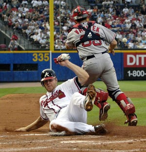 Atlanta's Scott Thorman slides safely into home during the Braves' 9-4 win over the Red Sox.