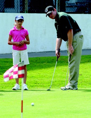 Massachusetts Golf Association’s Joe McCabe, director of the First Tee program, gives putting pointers to Jessie Beynor at Hyannis Golf Club Monday.