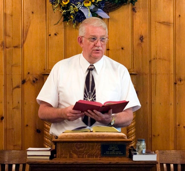 The Rev. Danny Fleming preaches at Big Isaac United Methodist Church in Big Isaac, W.Va. Sunday. Fleming, a part-time pastor, holds a full-time job with the U.S. Army in Clarksburg, W.Va., while he ministers to two churches some Sundays and three churches on other Sundays.