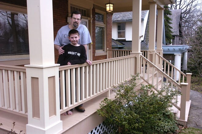 Tom Cahill and his son, Sam, 9, enjoy the porch that was added onto their Edgewood, Pa., home. The 400-square-foot porch cost about $22,000.