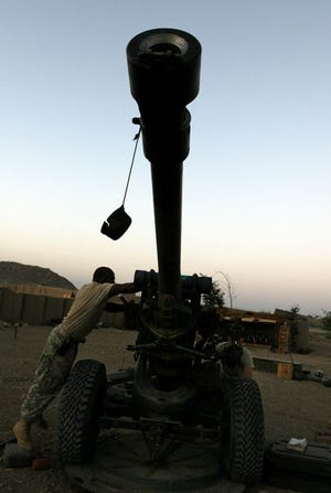 A soldier cleans artillery at a joint Afghan and U.S. military command center in Ghazni province Saturday.