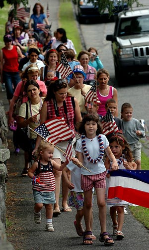 Children march down Common Street in Southborough during the Southborough Public Library's annual Fourth of July parade Wednesday. Children marched through Town Hall and back to the library.