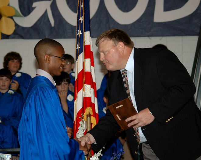 Maurice Thomas, eighth grade graduate from Raynham Middle School, is presented with the first Principal’s Award by Assistant Principal Richard Florence.