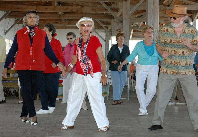 Rose Kabilian of Weymouth, center, shows everyone how to do the Electric Slide while the Neal Perry Orchestra performs at the Bernie King Pavilion on Nantasket Beach in Hull yesterday.