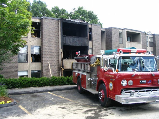 A fire engine sits outside the scene of Monday night's condominium blaze at Shrewsbury Green in Shrewsbury on Tuesday.