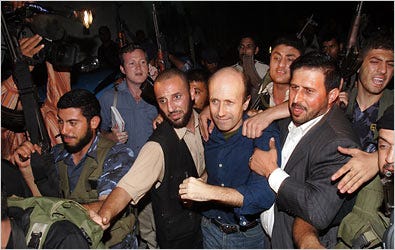 BBC reporter Alan Johnston, center right, as he was escorted to meet Hamas leader Ismail Haniyeh following his release in Gaza City.