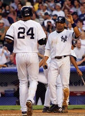 NEW YORK - JULY 03: Robinson Cano #24 of the New York Yankees is met at home by teammate Bobby Abreu #53 after his fourth inning two run home run against the Minnesota Twins at Yankee Stadium on July 3, 2007 in the Bronx borough of New York City. (Photo by Jim McIsaac/Getty Images)