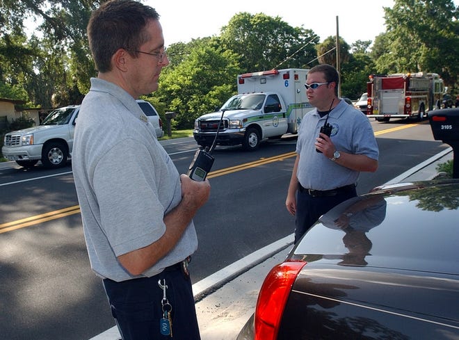 Joel Walker, left, and Gregory Welch, both of the Ocala EMS, respond to a recent accident in Florida. No one was hurt. Emergency responders are often delayed by drivers who will not yield the right of way.