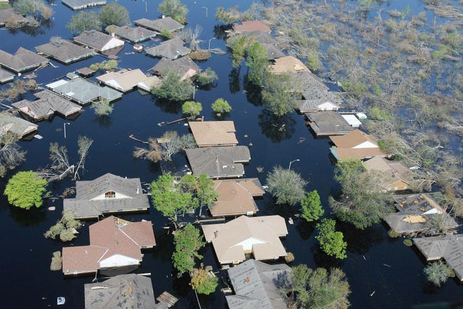 Water is at roof levels after Hurricane Katrina. Generally, if a house is flooded during a hurricane, the damage is not covered by a homeowner’s insurance policy.