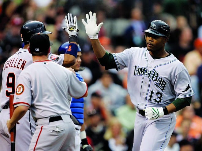 Carl Crawford (right) hit one of three home runs for the American League, which has home-field advantage in the World Series.