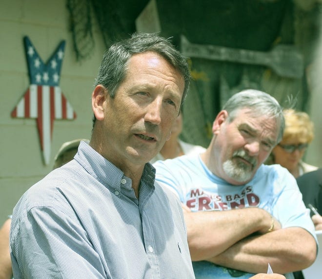 South Carolina Governor Mark Sanford (r) met with local small business owners at Brown's Bait and Tackle in Duncan to address the impact an economic development bill recently passed by the state Legislature would have on local retailers. Store owner Rhett Brown (r) listens