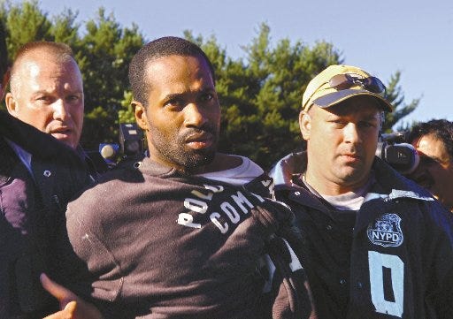 Robert Ellis, center, is taken into the Pennsylvania State Police barracks in Swiftwater Thursday. Ellis, wanted in a vicious New York City cop shooting on Monday, was captured around 8 a.m. on Thursday off the westbound lanes of Interstate 80 near the Interstate 380 junction, near the spot where suspect Dexter Bostic was found Wednesday evening.