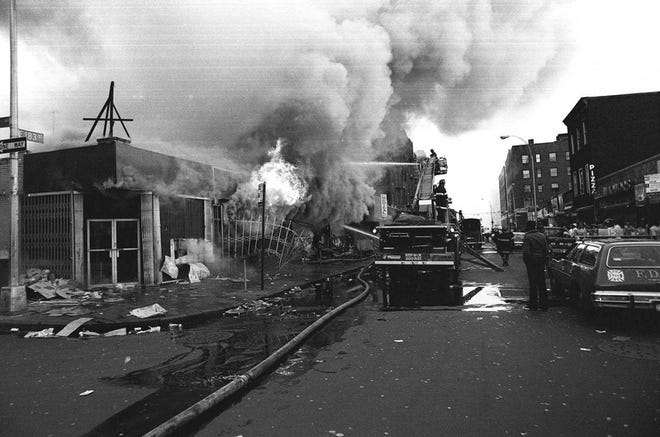 Firefighters in the Bronx battle flames in one of the many fires raging in stores throughout New York City during the blackout in this July 14, 1977, photo.