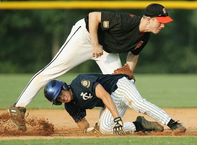 Will Keel of Irmo/Chapin tries to get under the tag made by Spartanburg's Aaron Story during Monday's opening round of the state American Legion playoffs.