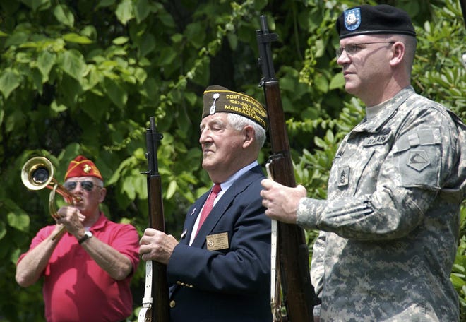 Right to left, John Ryan and Harry Seaholm honor the memory of Carlo Intinarelli with an honor guard gun salute in Natick on Saturday. Ed Jolley accompanied with a rendition of taps.