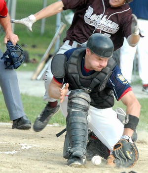 Norfolk catcher Brett Roye digs the ball out of the dirt during a play at home plate yesterday in the Legion game against Dedham.