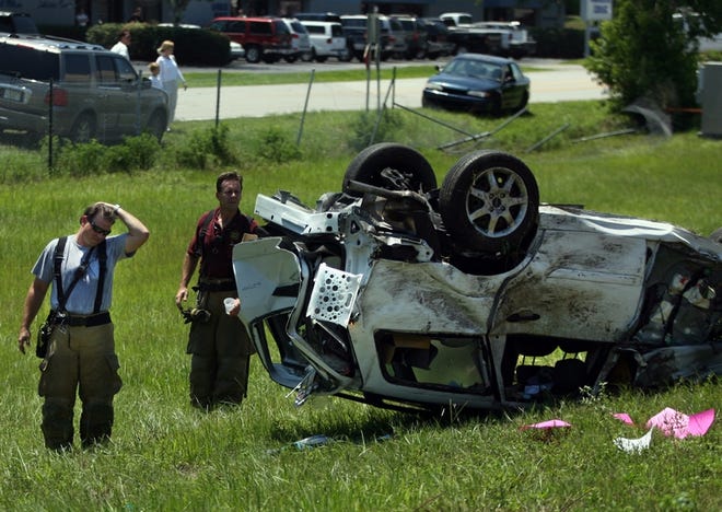 Firefighters examine a car that caused an accident on Interstate 75 in Ocala on Wednesday.