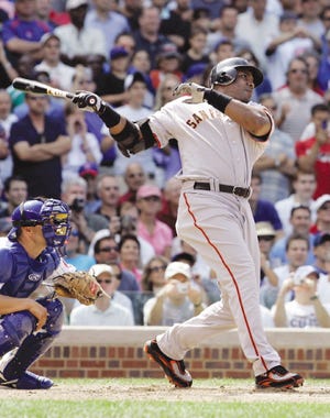 San Francisco's Barry Bonds hits a three-run home run in the seventh inning against the Cubs Thursday afternoon at Wrigley Field in Chicago. It was his 753rd career home run.