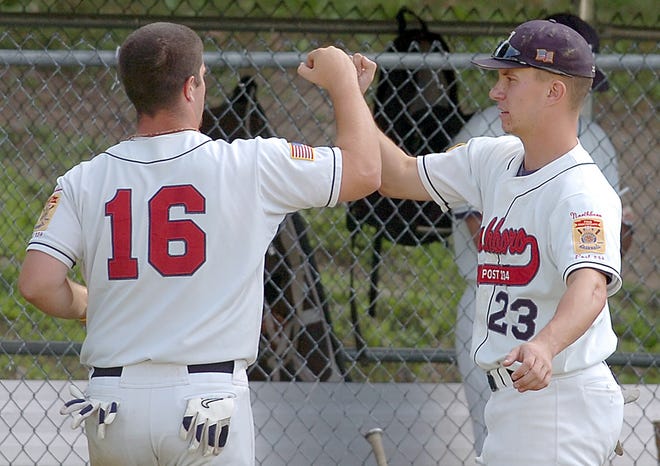 Northborough Legion's Alex Dion (23) welcomes home Graham Henningson after a run during last night's 16-1 victory over visiting North County.