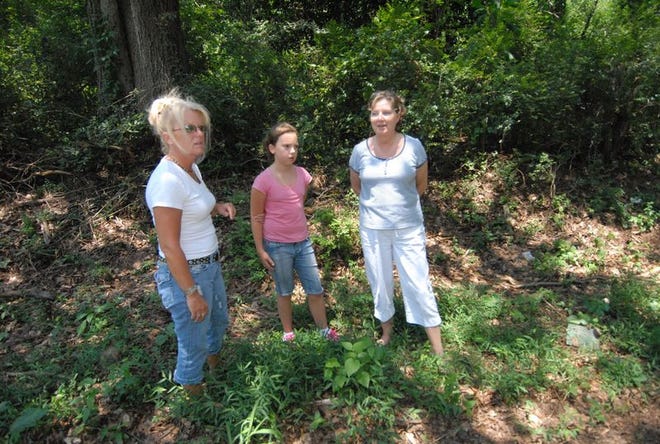 Sisters Cindy Frey and Beth McNeill, with Frey's granddaughter, Madeline McAbee, on Carver Mill Road.