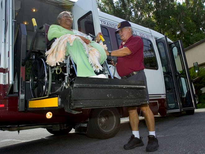 Marion Transit Services driver Buddy Geer assists Barbara Crowell at the Ocala Regional Kidney Center in Ocala.