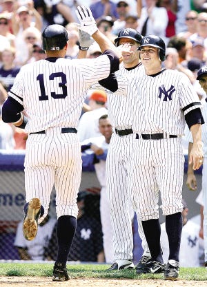 NEW YORK - JULY 08: Andy Phillips #12 and Johnny Damon #18 high five team mate Alex Rodriguez #13 of the New York Yankees after he hit a three run home run against the Los Angeles Angels of Anaheim during their game on July 8, 2007 at Yankee Stadium in the Bronx borough of New York City. (Photo by Chris McGrath/Getty Images)