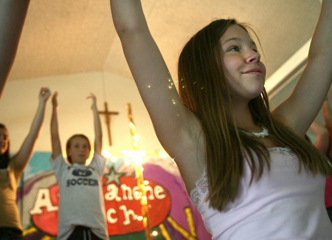 Emily Marshall, 12, of Raynham sings at Avanlanche Ranch summer Bible camp at St. Ann’s Catholic Church in Raynham.