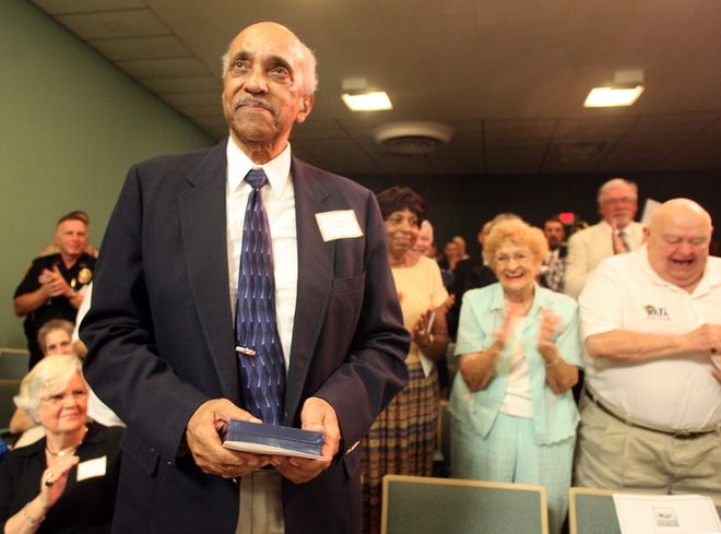 Haldane King pauses as attendees give him a standing ovation at a service honoring the Tuskegee Airmen at the Marion County Commission room in Ocala on Monday.