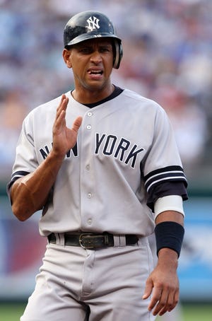 Alex Rodriguez arrives at first base after being hit by a pitch during the first inning against the Royals last night in Kansas City, Mo.