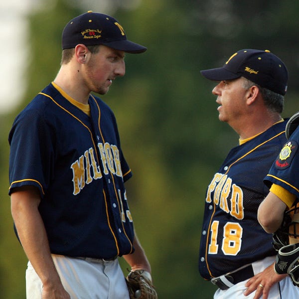 Milford manager Rich Piergustavo (right) talks with starting pitcher Derek Zahka during Post 59's loss to Westfield.