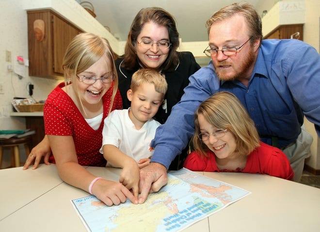 The Welsch family, of Ocala, looks over a map of where they will be going as missionaries in Pakistan. Clockwise from top right, Mike, Chelsea, 10, Mickey, 4, Caitlyn, 12, and Alisa. The Welsches have been to Pakistan as missionaries twice before and plan to go again later this year.