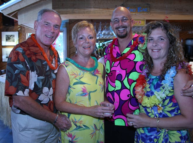 From left: Warren and Gail Onken, along with Jim and Vikki Leahy, dressed in their best Hawaiian attire for the "Hula on the Hill" summer fundraiser. Jim Leahy won the men's best Hawaiian shirt competition while his wife placed third in the women's Hawaiian dress competition.